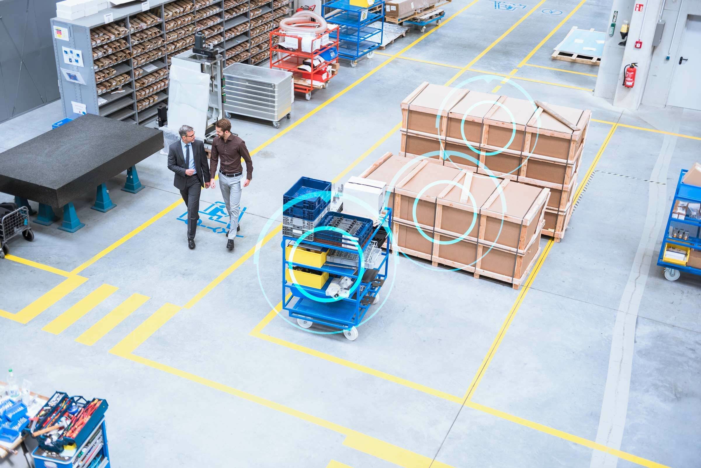 two workers walking through warehouse