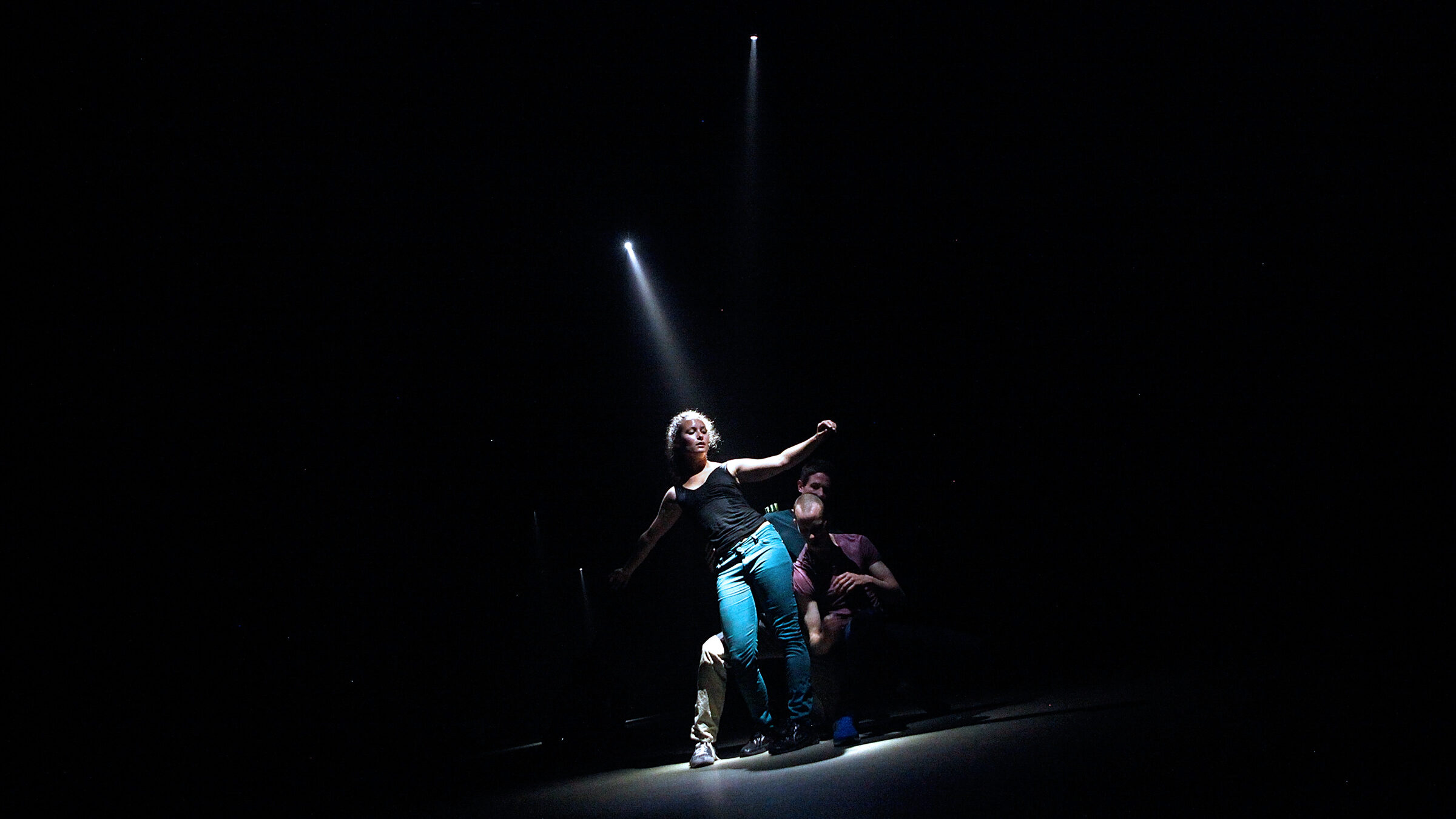 dancers on stage in spotlight