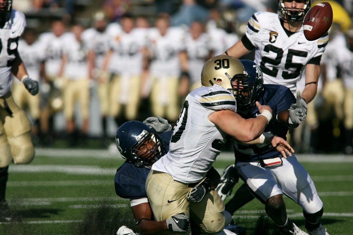 A football player is injured while making a tackle during a game.