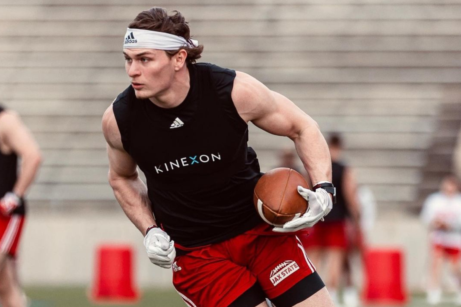 An American football player wears a sports vest with a player tracking device during training.