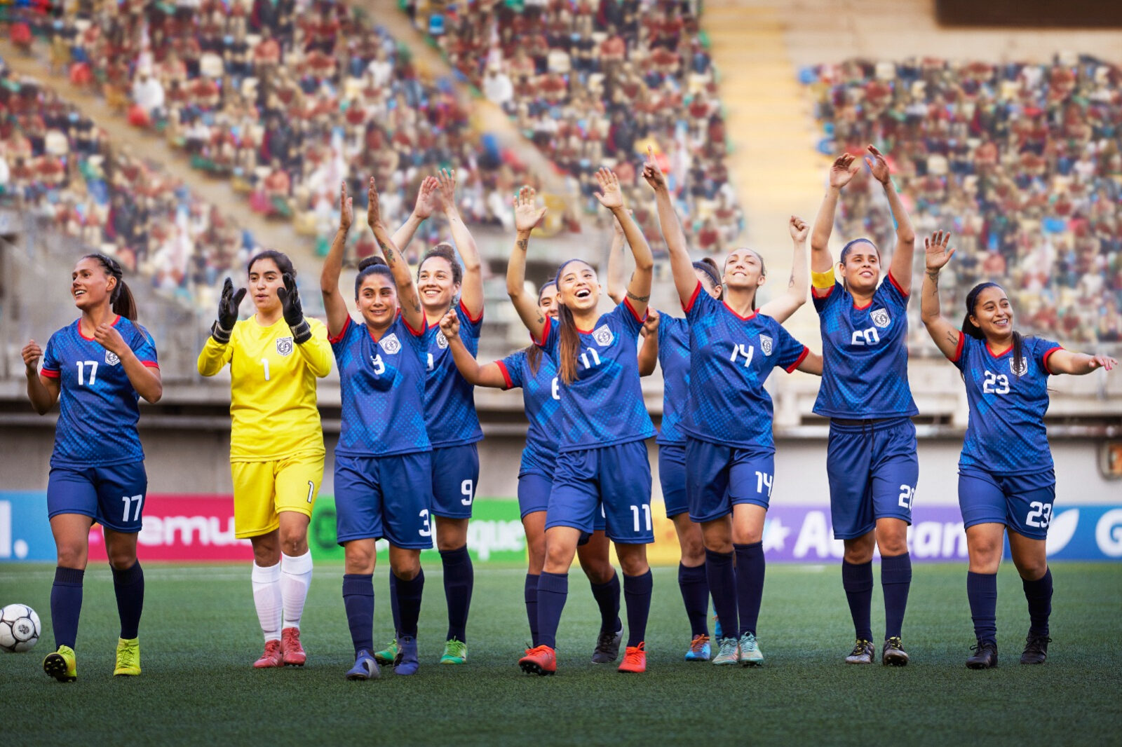 A group of women athletes celebrate a win.