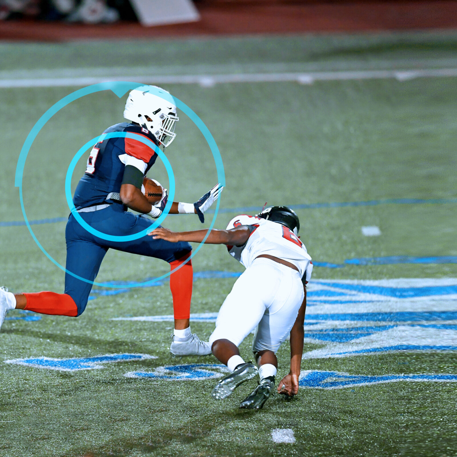 Great action shots of high school football player making an amazing run during a football game while his coaches monitor his play with sports performance software.