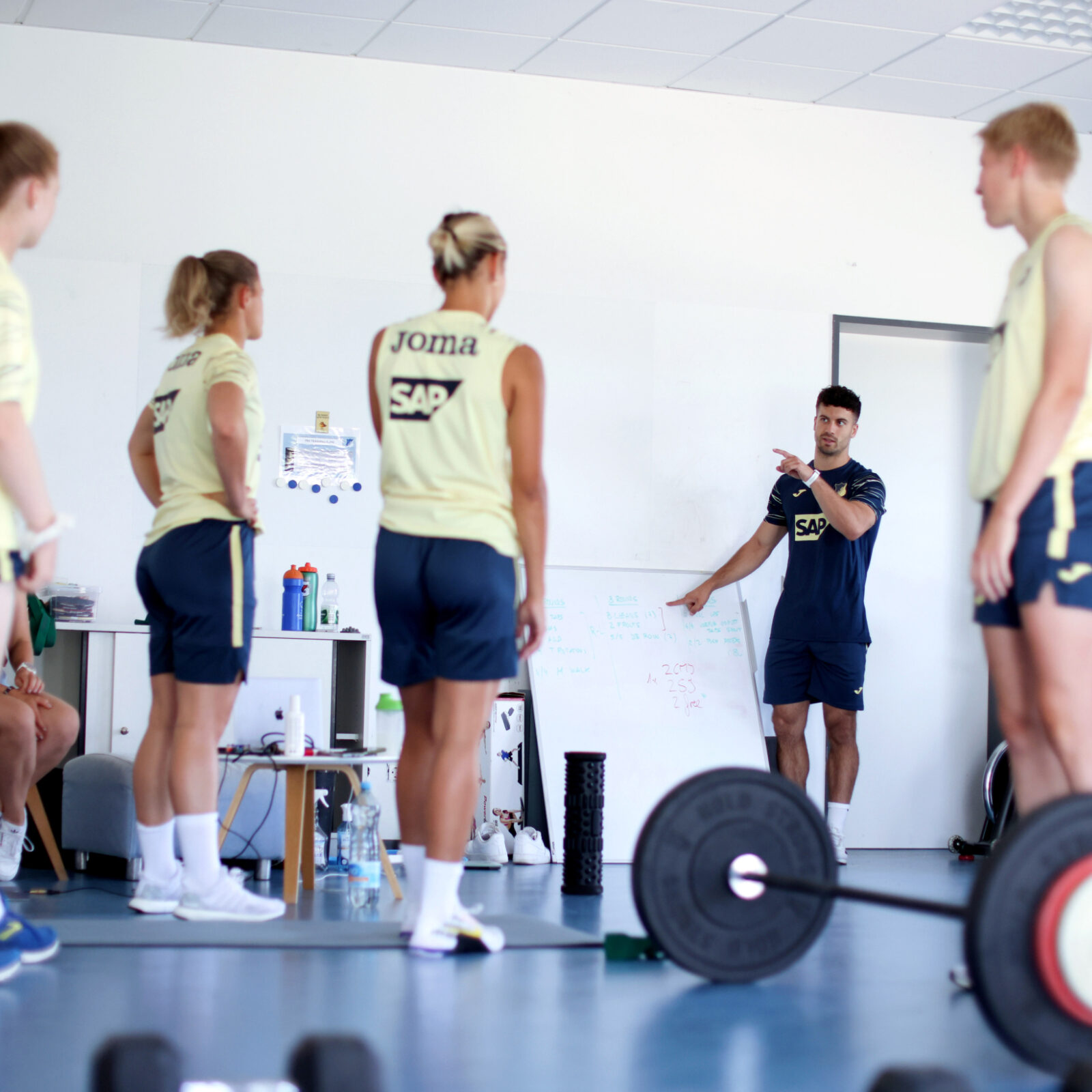 A sports scientist works with an athlete during a sports performance training session.