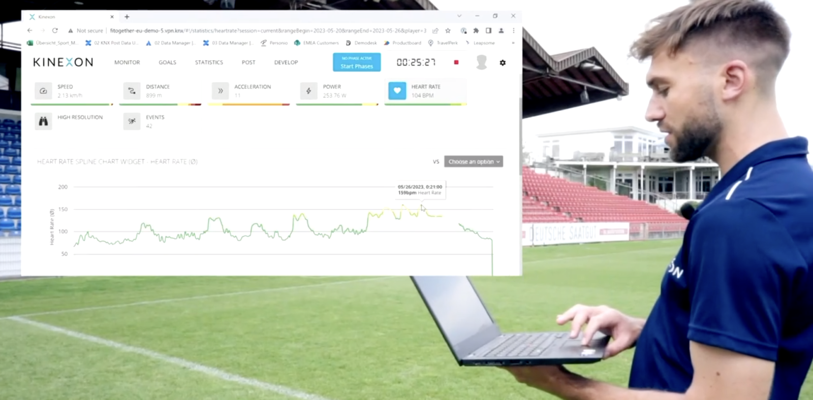 A coach analyzes the information he is receiving from a sports heart rate monitor in real-time.