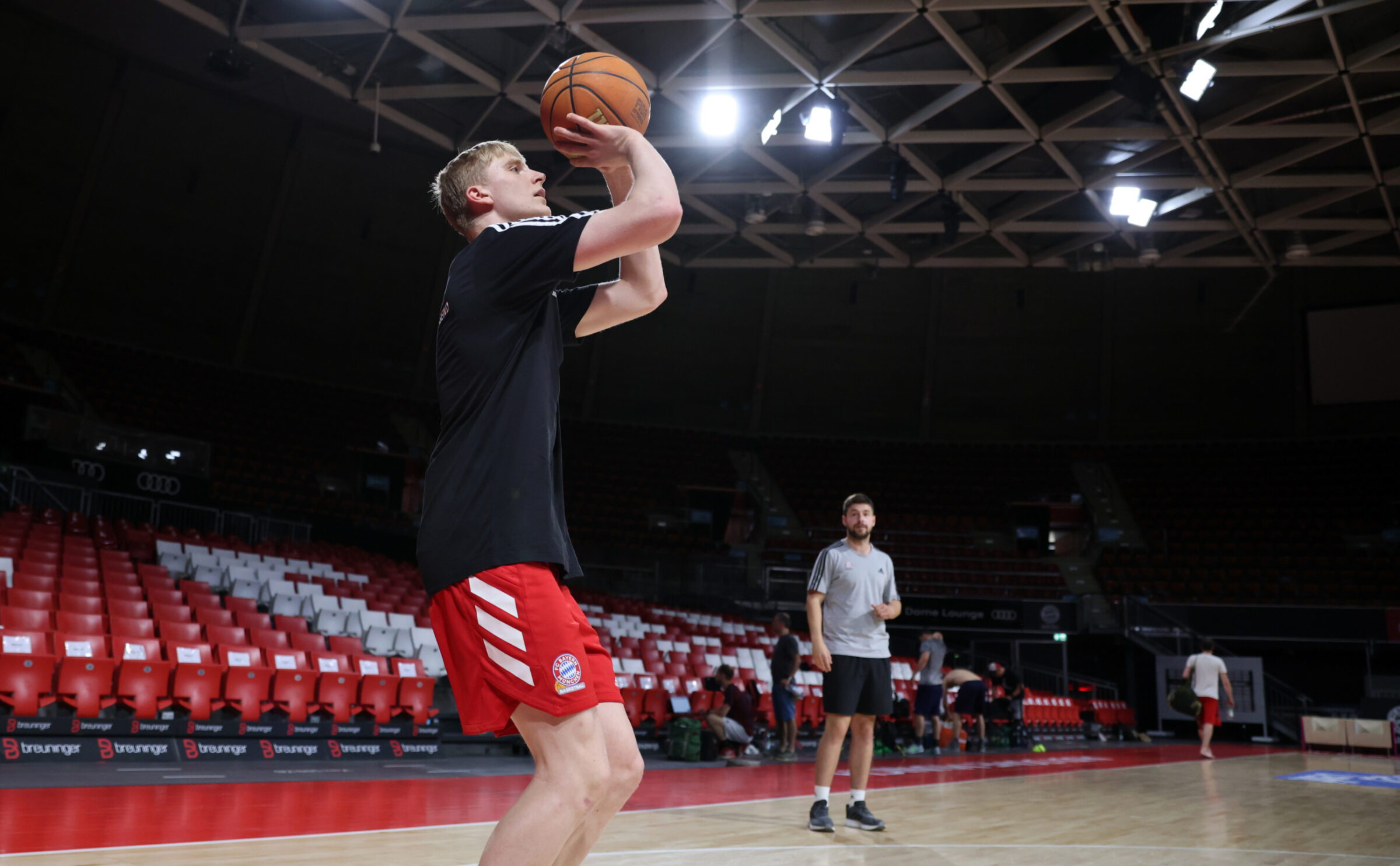 A player takes a shot while a coach uses basketball analytics to point out strengths and where he has the best chance of making them.