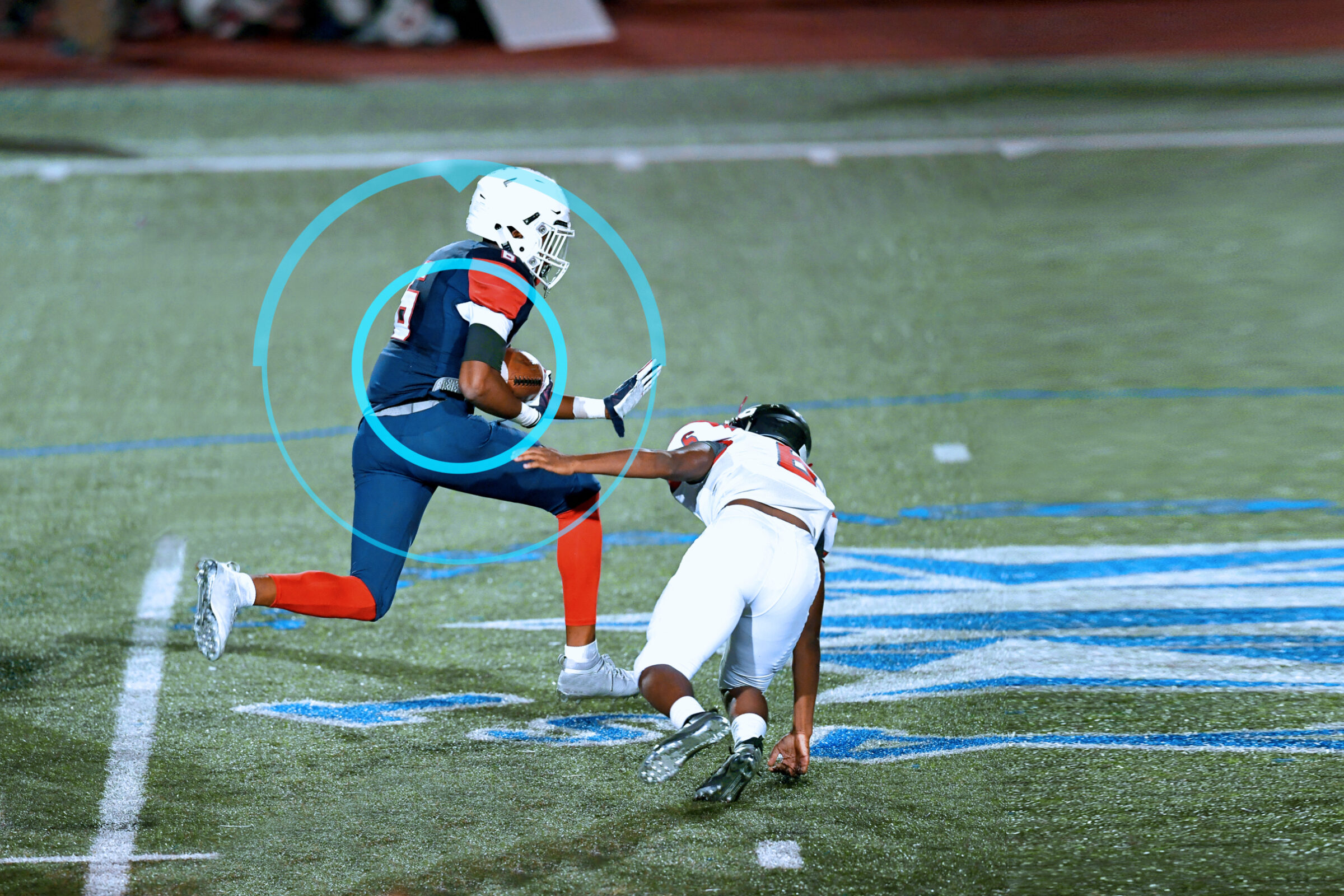 Great action shots of high school football player making an amazing run during a football game while his coaches monitor his play with sports performance software.