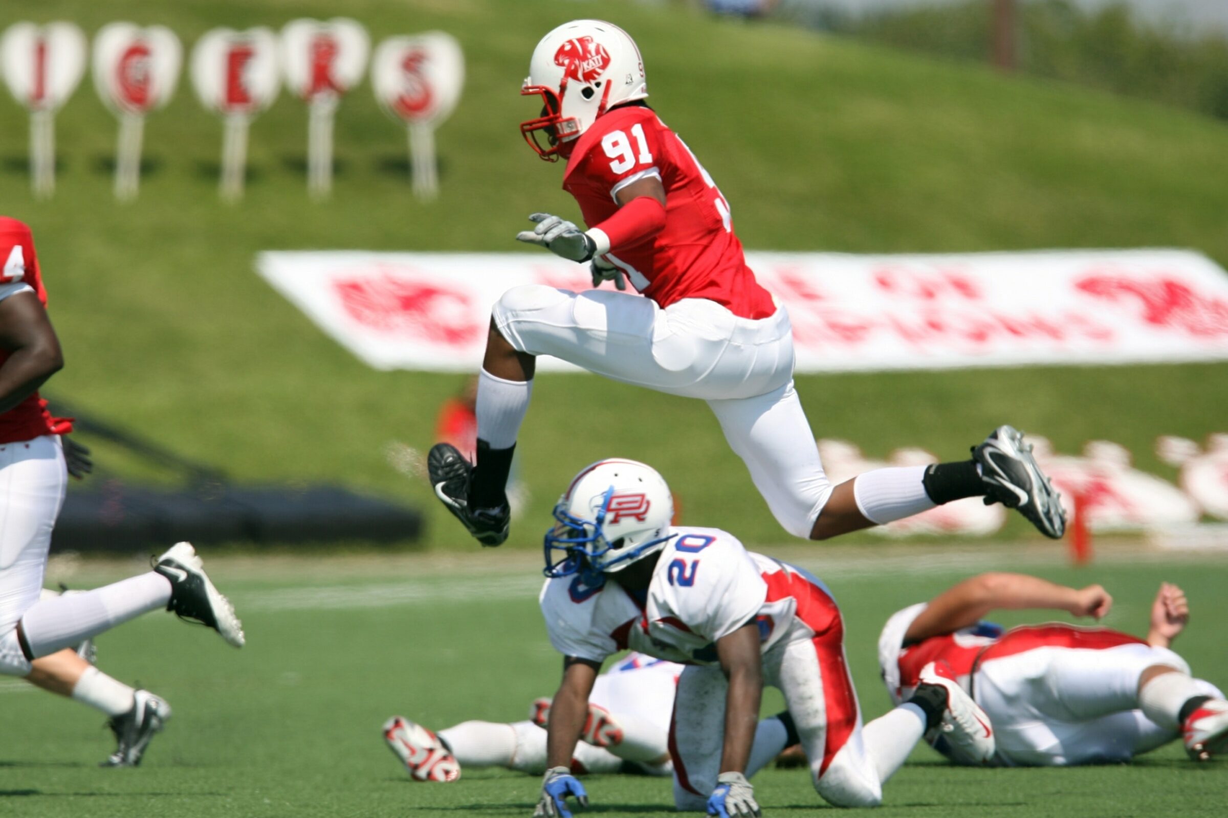 A defensive end gives chase as a running back tries to elude him during a tackle football game.