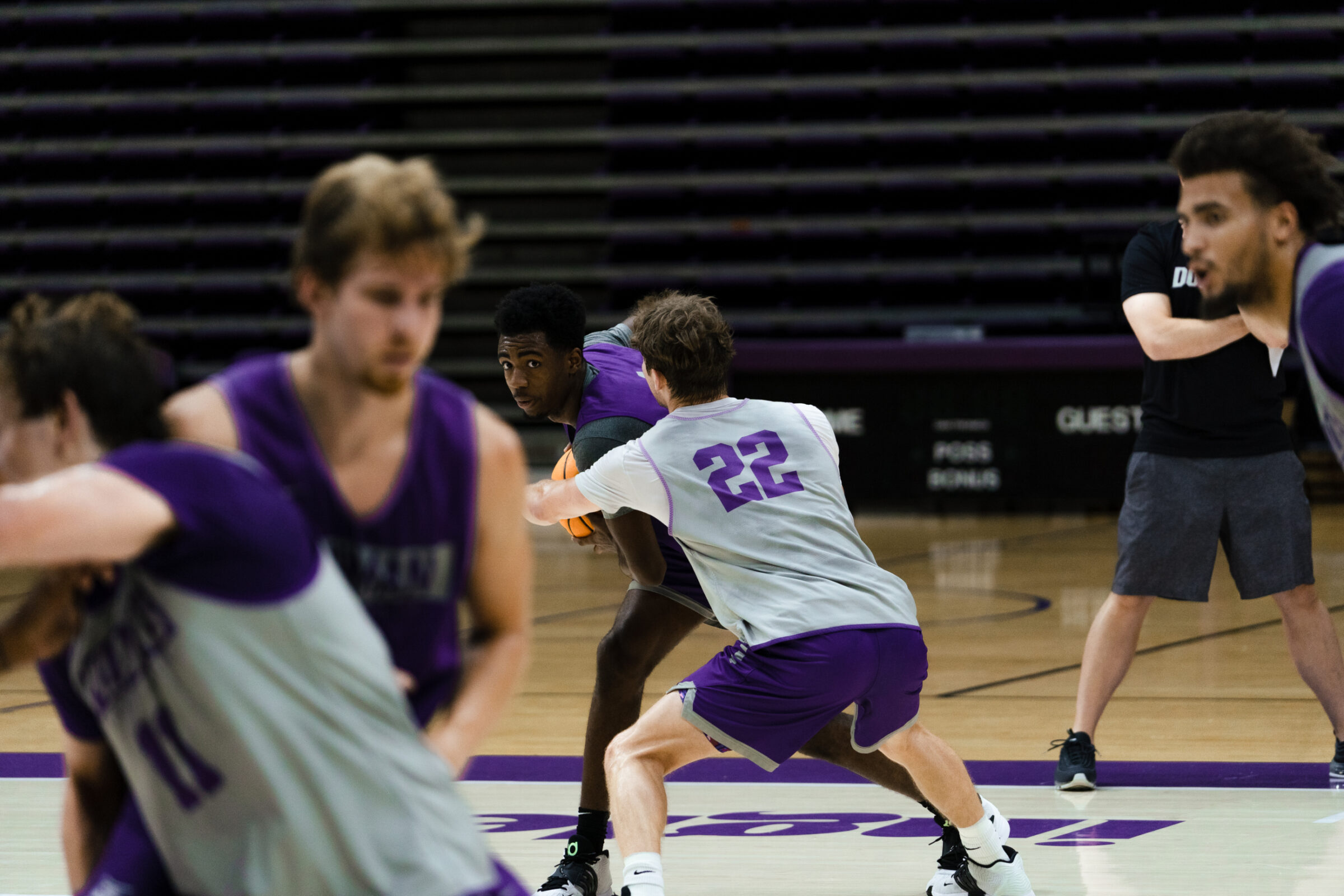 Basketball players practice while wearing devices that keep track of how much they are playing and for how long.