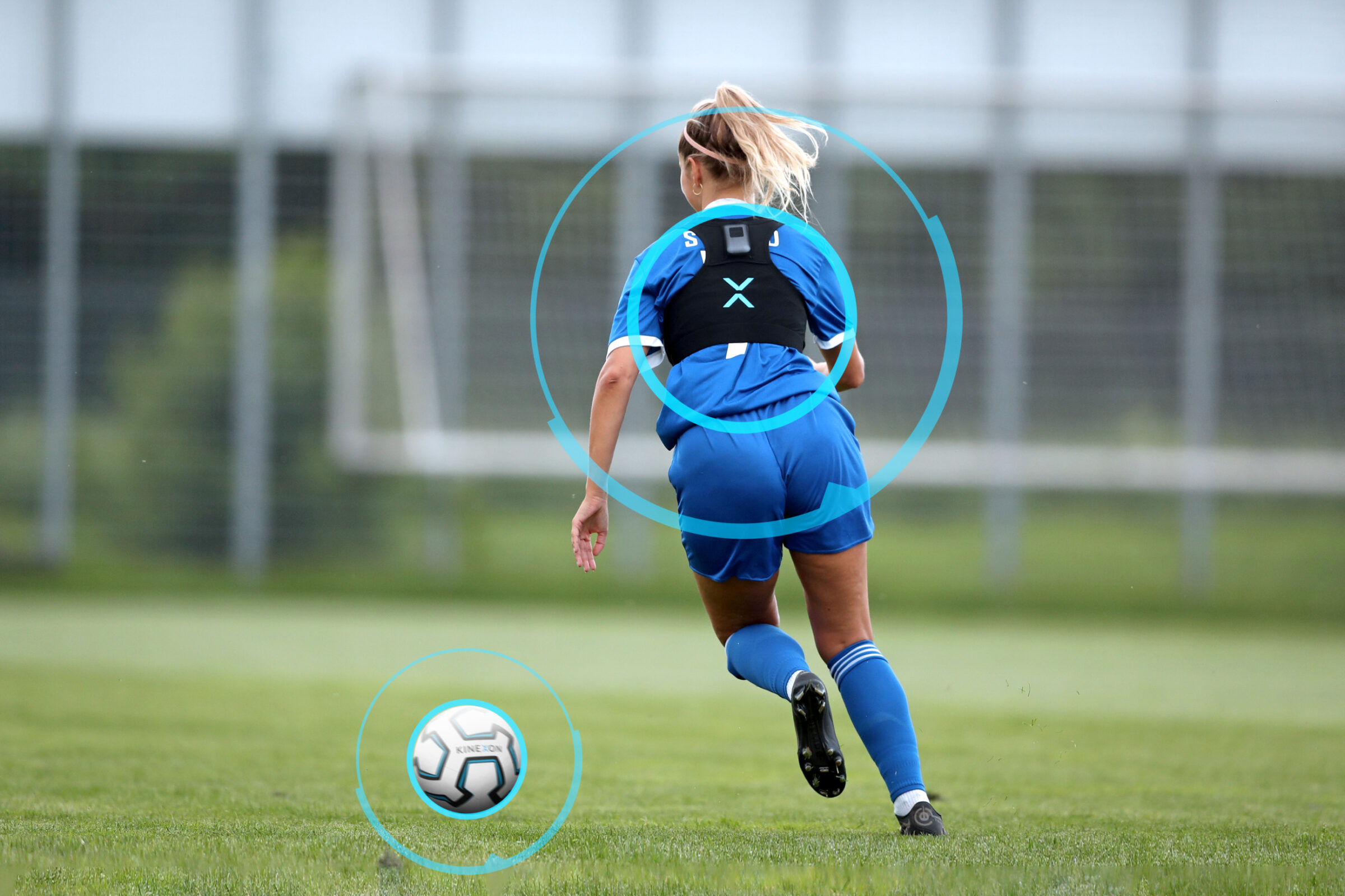 A women's football player wears a soccer vest while training for an upcoming match.