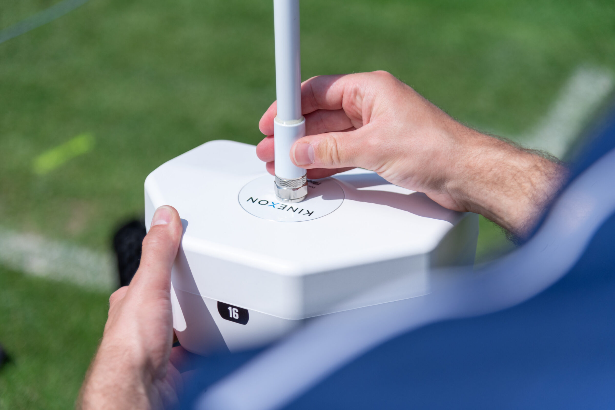 A sports scientist uses a GPS antenna that works together with a player tracking device worn by players to collect sports data like movement and positioning.