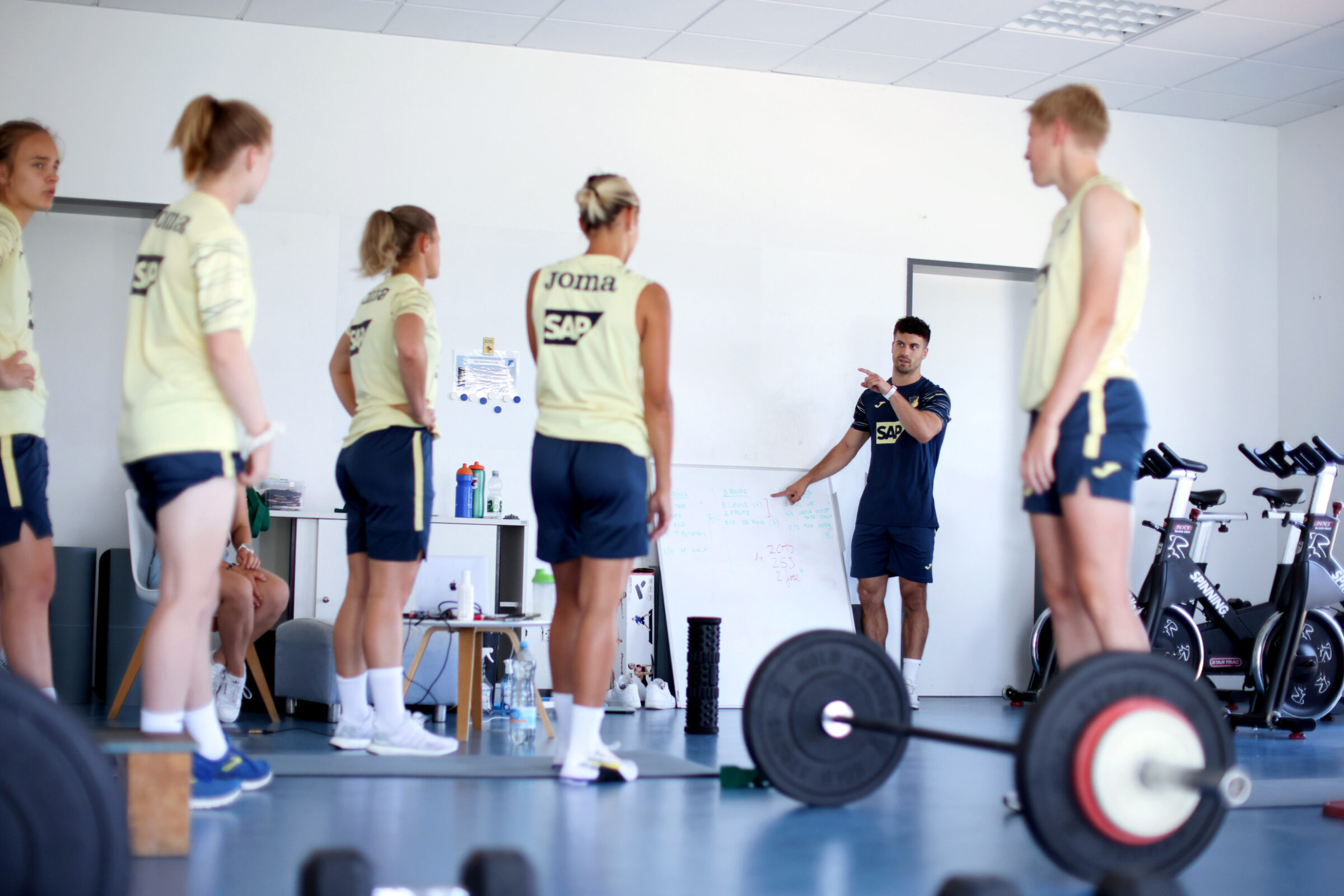 A sports scientist works with an athlete during a sports performance training session.