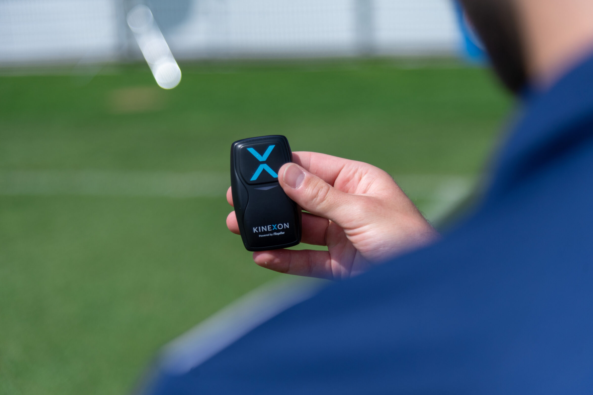 A sports scientist holds a player tracking sensor that is used to collect information on players like acceleration and deceleration and yardage.