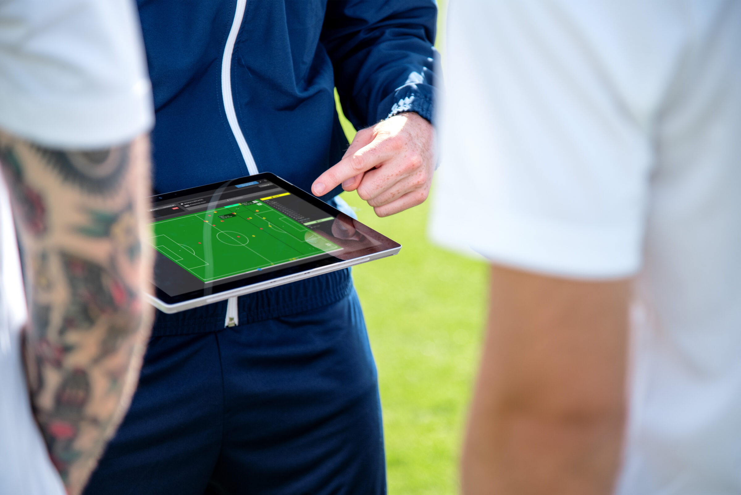 A coach reviews what he has learned from sports data analytics with players during a practice session.