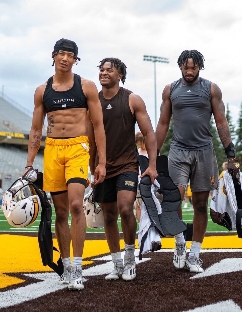 Members of the University of Wyoming football team wear football (soccer) vests under their practice and game uniforms that are equipped with player tracking sensors that store information like sprints and jumps.